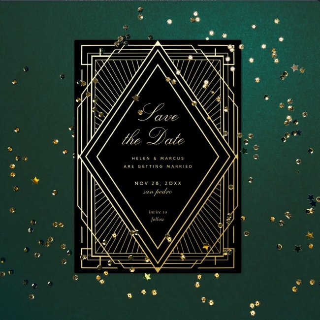Black Art Deco save the date card with gold foil geometric design on green background with confetti.