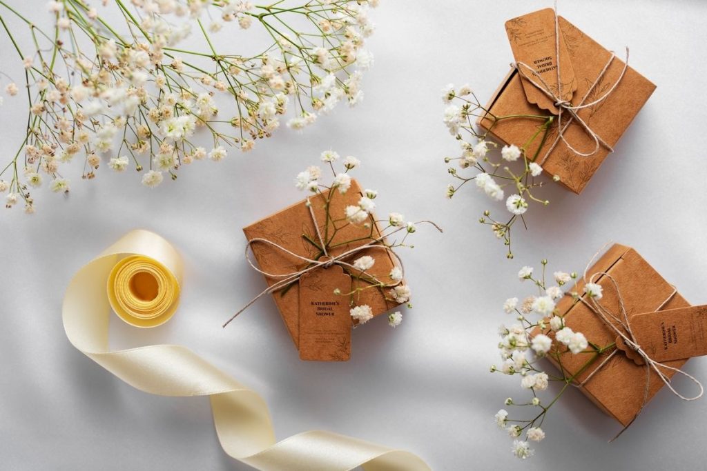 Bridal shower favors wrapped in brown kraft paper with twine and baby's breath flowers.