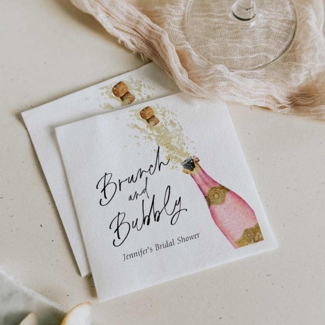 Brunch and Bubbly bridal shower napkins with pink champagne bottle design