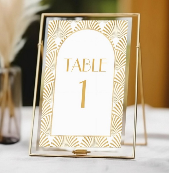 Elegant gold and white geometric Art Deco wedding table number in a gold frame reading "Table 1."