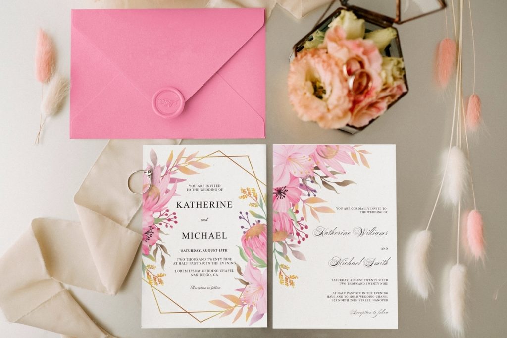 Elegant floral wedding invitation styles with pink and gold watercolor blooms, matching RSVP card, and pink envelope.