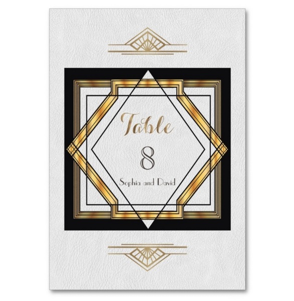 Great Gatsby gold and white Art Deco wedding table number card with geometric diamond design.