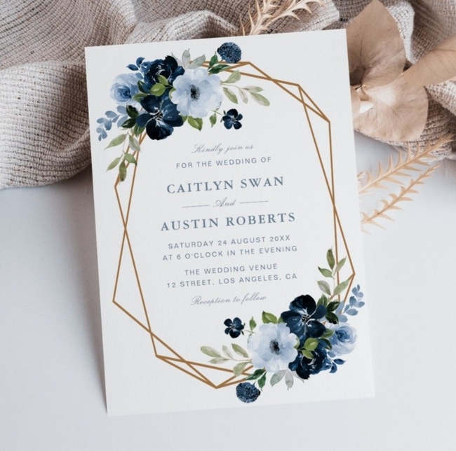 Navy and light blue floral wedding invitation style with gold geometric frame.
