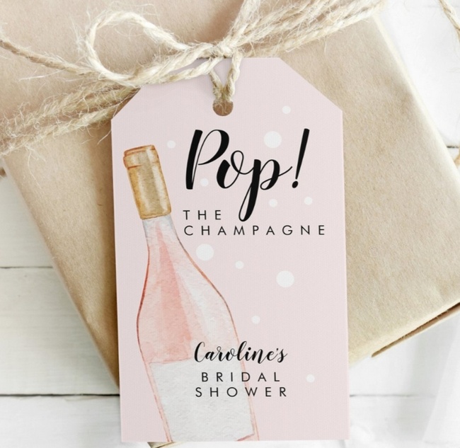 Pink “Pop the Champagne” bridal shower favor tag with champagne bottle illustration.
