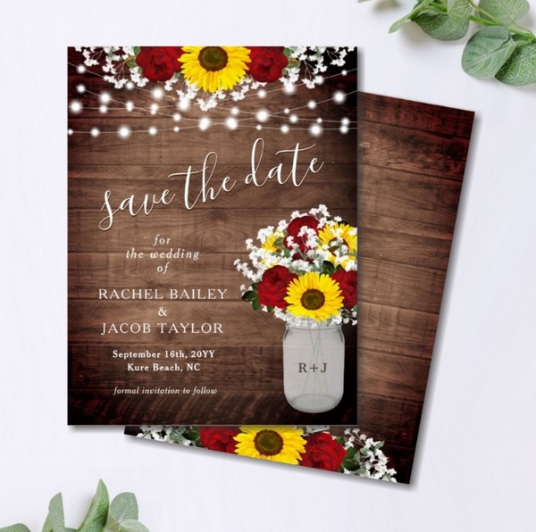 Rustic save the date postcard with sunflowers, mason jar bouquet, and string lights on a wood background.