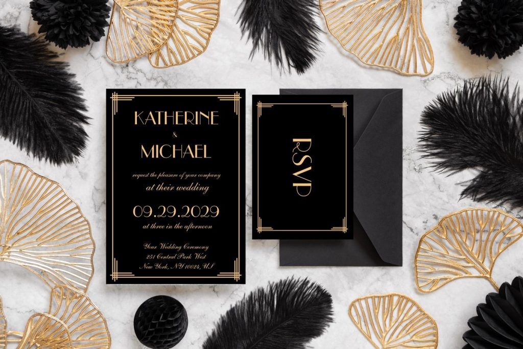 Art deco wedding invitations in black and gold with RSVP card, styled with feathers and gold accents.