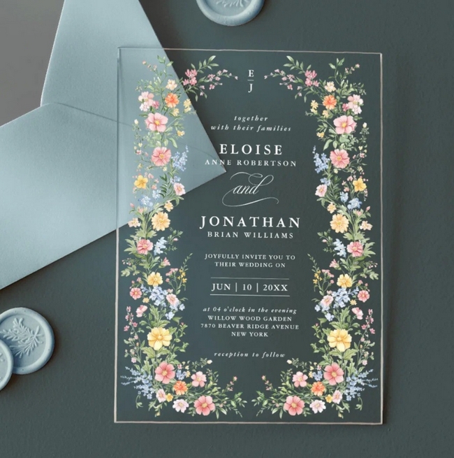 Clear acrylic wedding invitation with pastel floral border, blue envelope and wax seals in elegant spring garden style